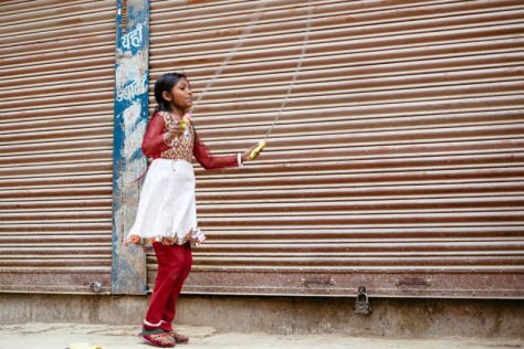 Nepalese girl jumping with a rope in Kathmandu, Nepal